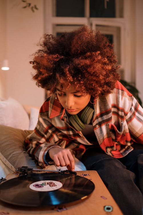 Free Photo of a Woman with Curly Hair Listening to Music Stock Photo