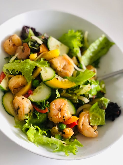 Fresh Vegetable Salad with Shrimps on White Ceramic Plate