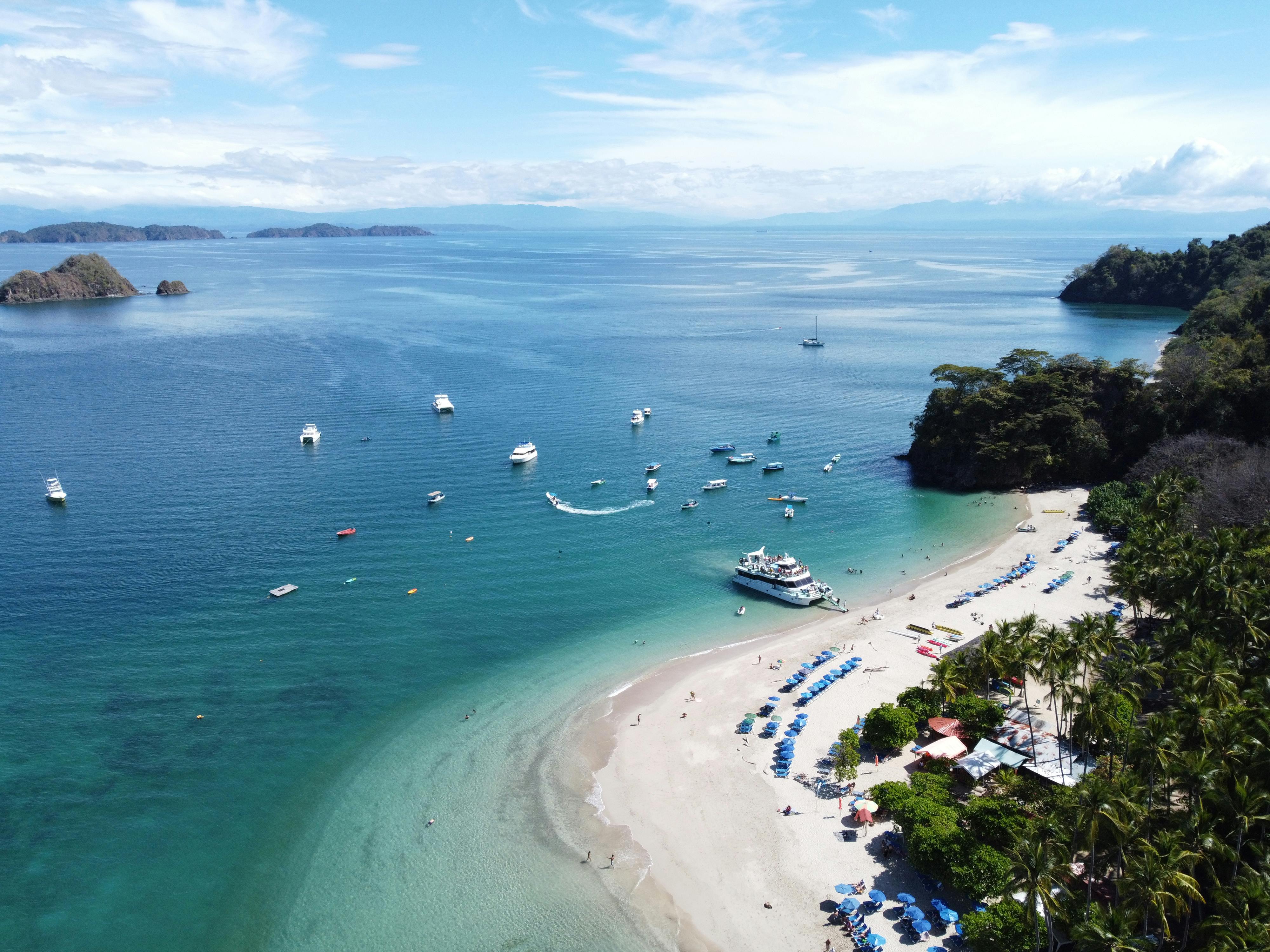 Aerial view of Pacific bay with boats and tropical greenery, Costa Rica
