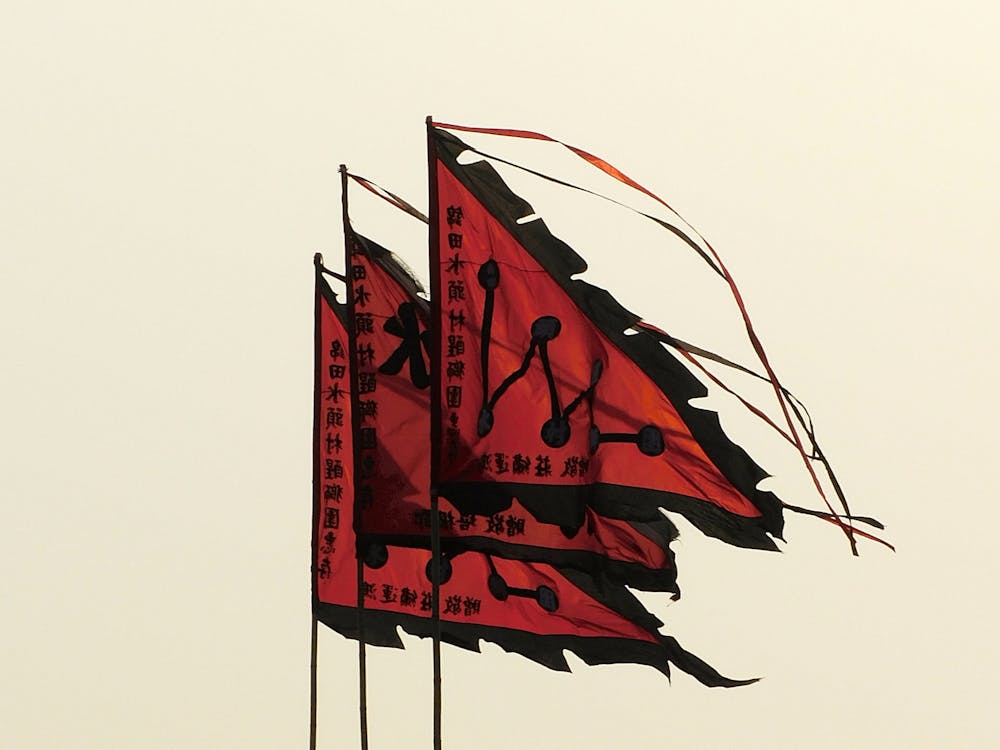 Red flags waving against overcast sky