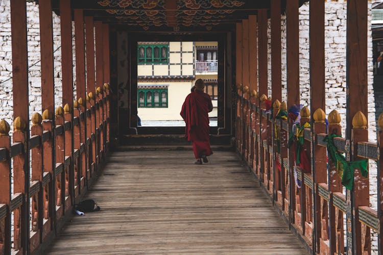 A Man Walking On Wooden Bridge