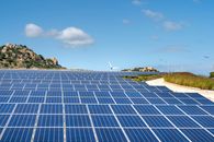 Solar Panels on Green Grass Field Under Blue Sky
