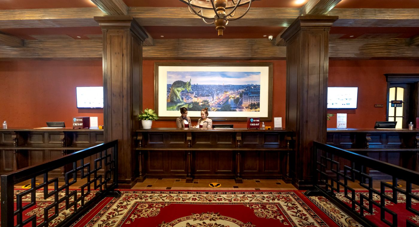 An elegant hotel reception desk in a warmly lit lobby