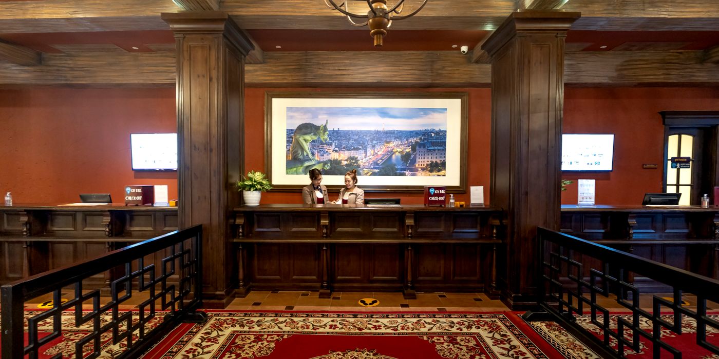 Wooden hotel reception desk in a classic lobby, illustrating how hotel rate parity rules changed pricing across booking platforms