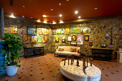 Free Elegant hotel lobby featuring artistic paintings and luxury decor, creating a welcoming ambiance. Stock Photo