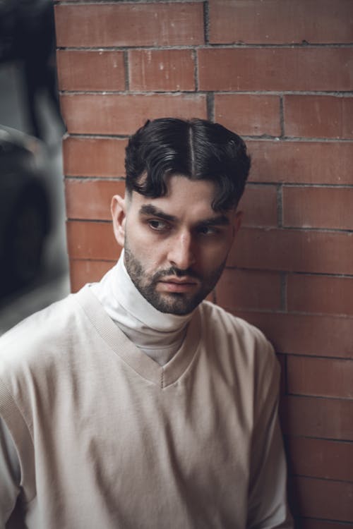 Photo of a Man with Facial Hair Wearing a Beige Top