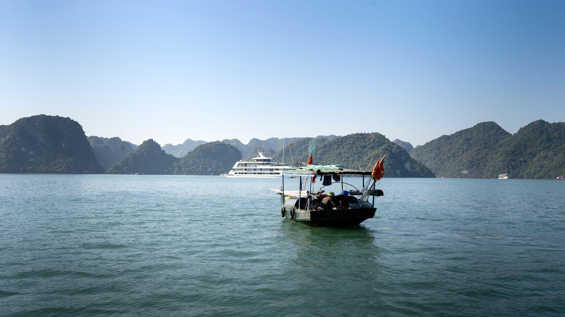 Traditional boat on Halong Bay with scenic islands in Vietnam.