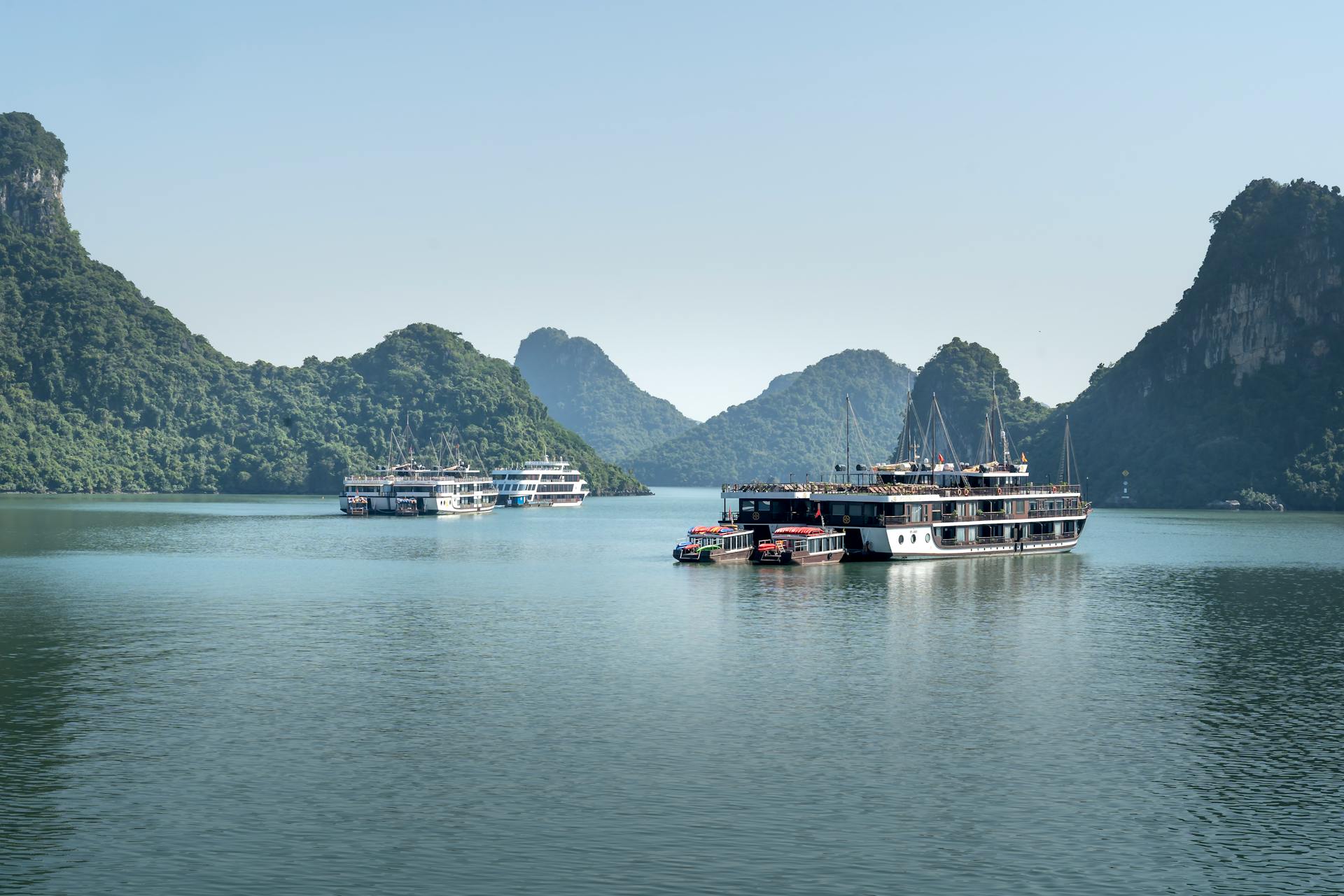 Stunning view of ferry boats navigating tranquil waters of Halong Bay, Vietnam.