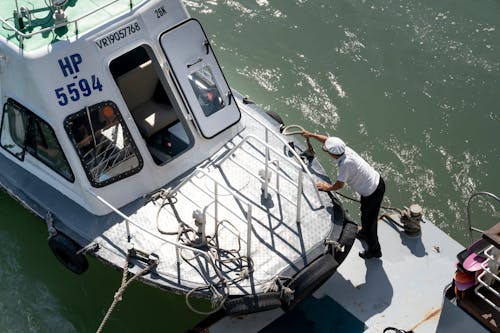 Free A Person Putting Rope in the Boat Stock Photo