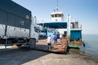 Cars and Trucks Driving onto a Ferry