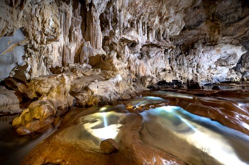 Free Explore the beauty of limestone formations inside a mysterious cave with stalactites. Stock Photo