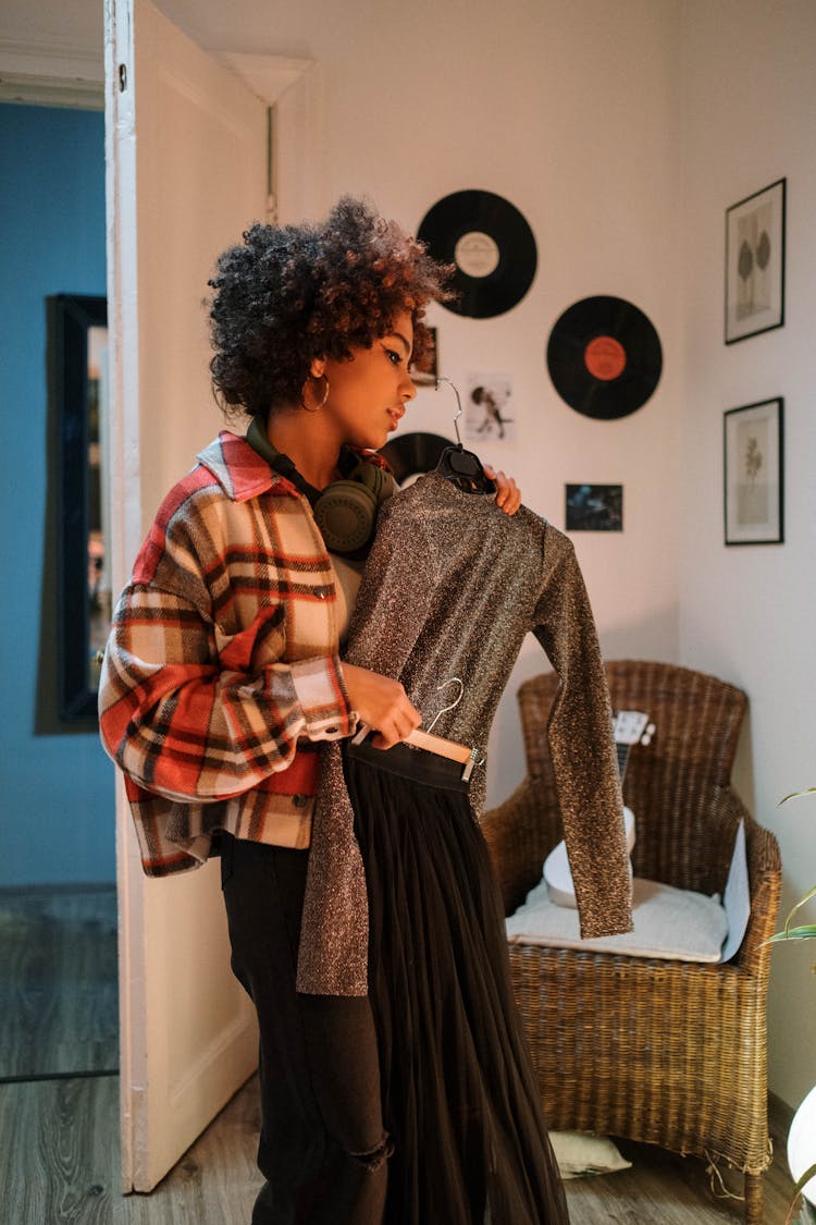 Woman Fitting Clothes While Standing