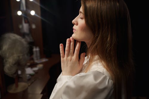 Woman in White Long Sleeve Shirt Praying 