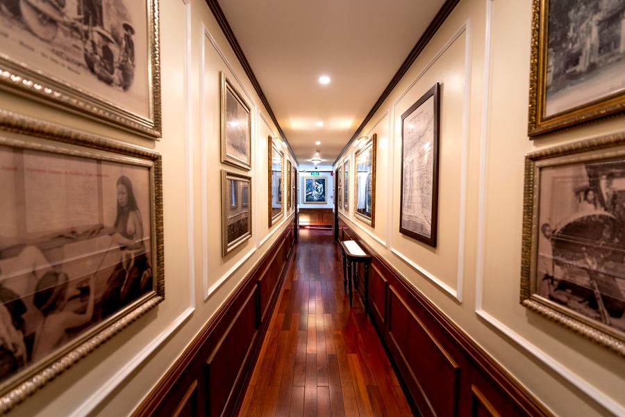 A long hallway hung with framed prints