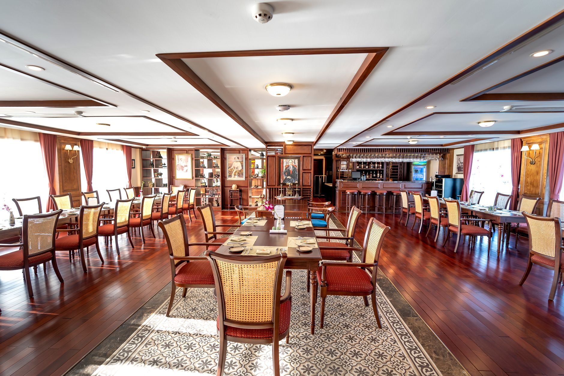 Luxurious hotel restaurant featuring elegant wooden decor and polished furniture setup.