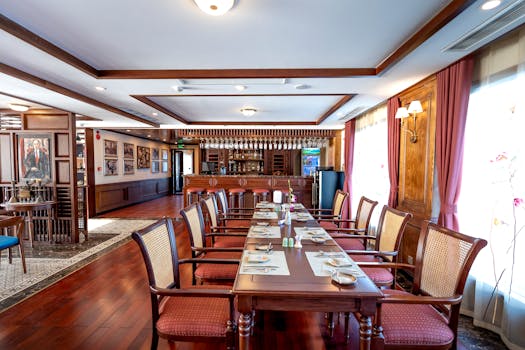 Spacious rustic restaurant interior with wooden furniture and classic decor ready for diners.