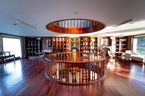 Free Spacious interior with luxurious wooden flooring and modern circular railing design. Stock Photo