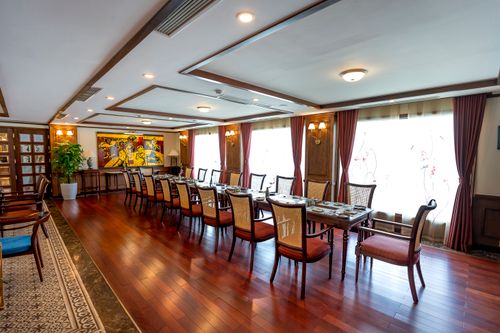 Free Spacious dining room featuring elegant tables, chairs, and artistic decor. Stock Photo