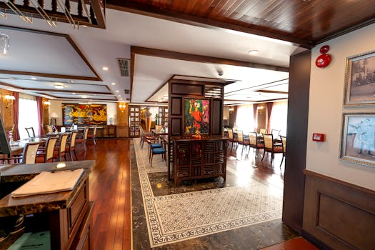 Luxurious hotel restaurant with elegant decor and wooden flooring.