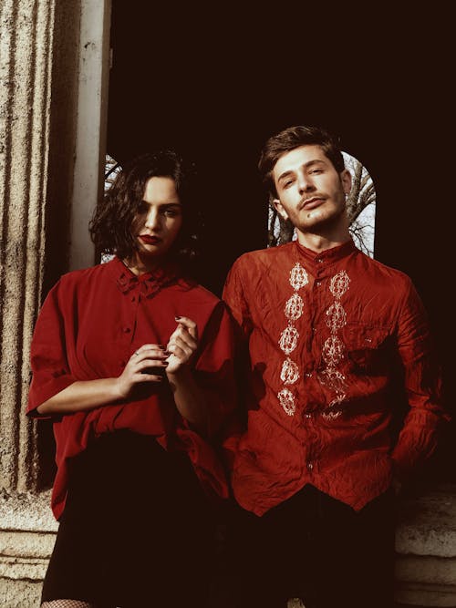 Photo of a Man and a Woman Wearing Red Shirts