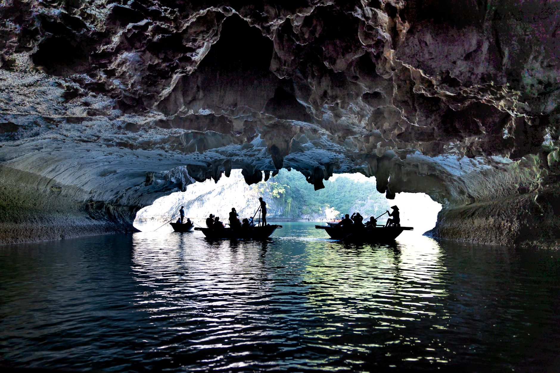 underground river cave with limestone formations and boat