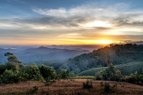 Free Stunning mountain landscape with misty fog and sunrise. Ideal for nature and travel themes. Stock Photo