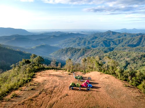 Free Breathtaking aerial view of a mountain campsite with colorful tents at sunrise, overlooking vast landscapes. Stock Photo