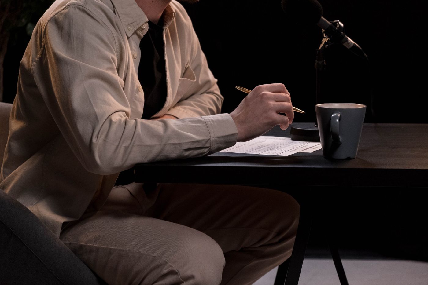 Instructor recording a lesson at a studio desk — photo by cottonbro studio on Pexels
