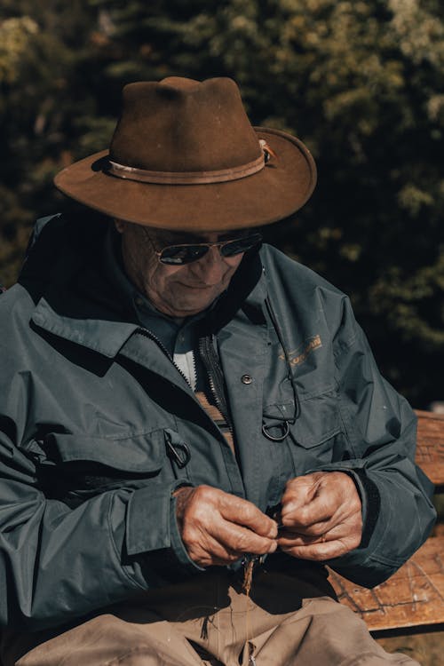 Free Photo of an Elderly Man in a Blue Jacket Wearing a Brown Hat Stock Photo