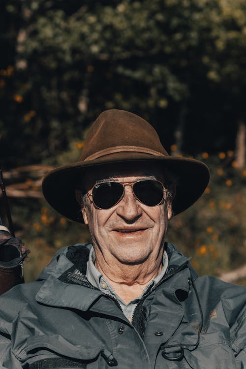Free Portrait of an Elderly Man with a Brown Hat Wearing Sunglasses Stock Photo