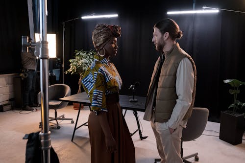 Model Standing with Man in Vest at Studio