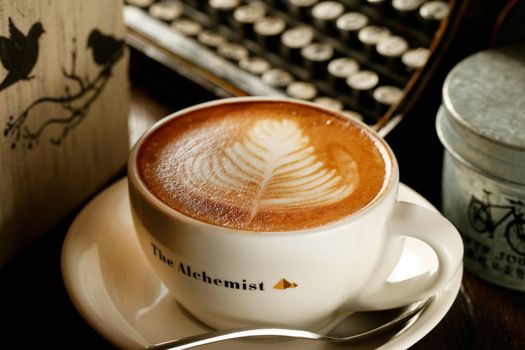 Close-up of a beautifully crafted latte art in a cafe setting, perfect for cozy atmosphere themes.