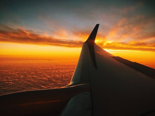 Window Plane Photography of Sunset