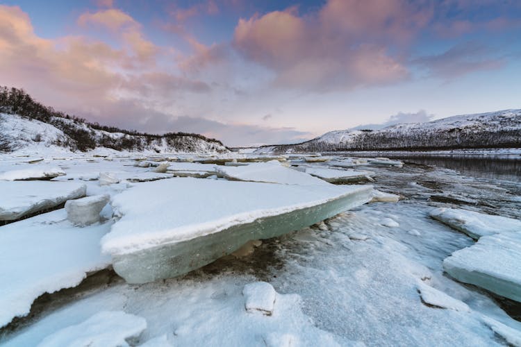 Snow Covered Mountain Near Frozen Lake