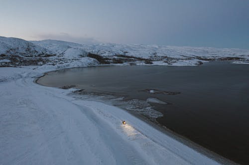 A Snow Covered Landscape Near the Lake