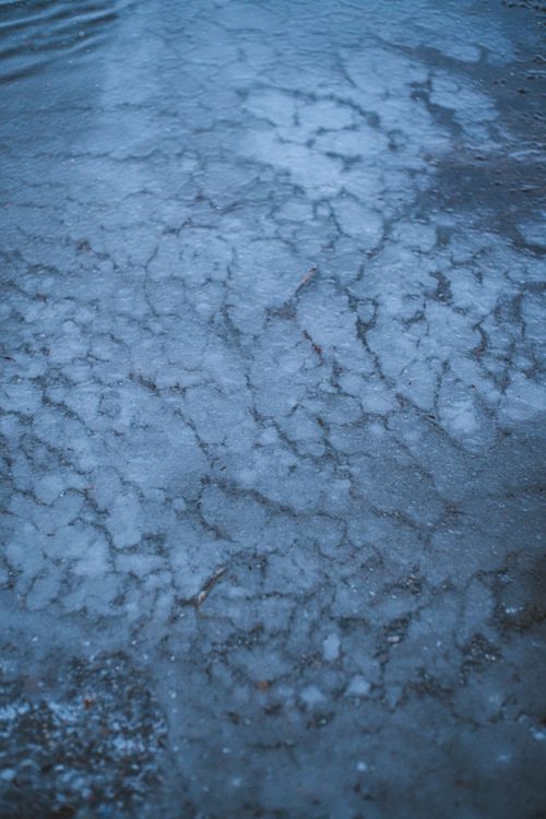 Free Intricate patterns of ice on a flat surface in the winter season. Stock Photo