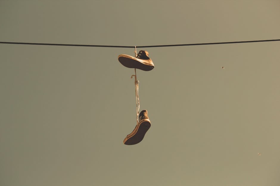 White Black High Top Shoes Hanging on Electric Line