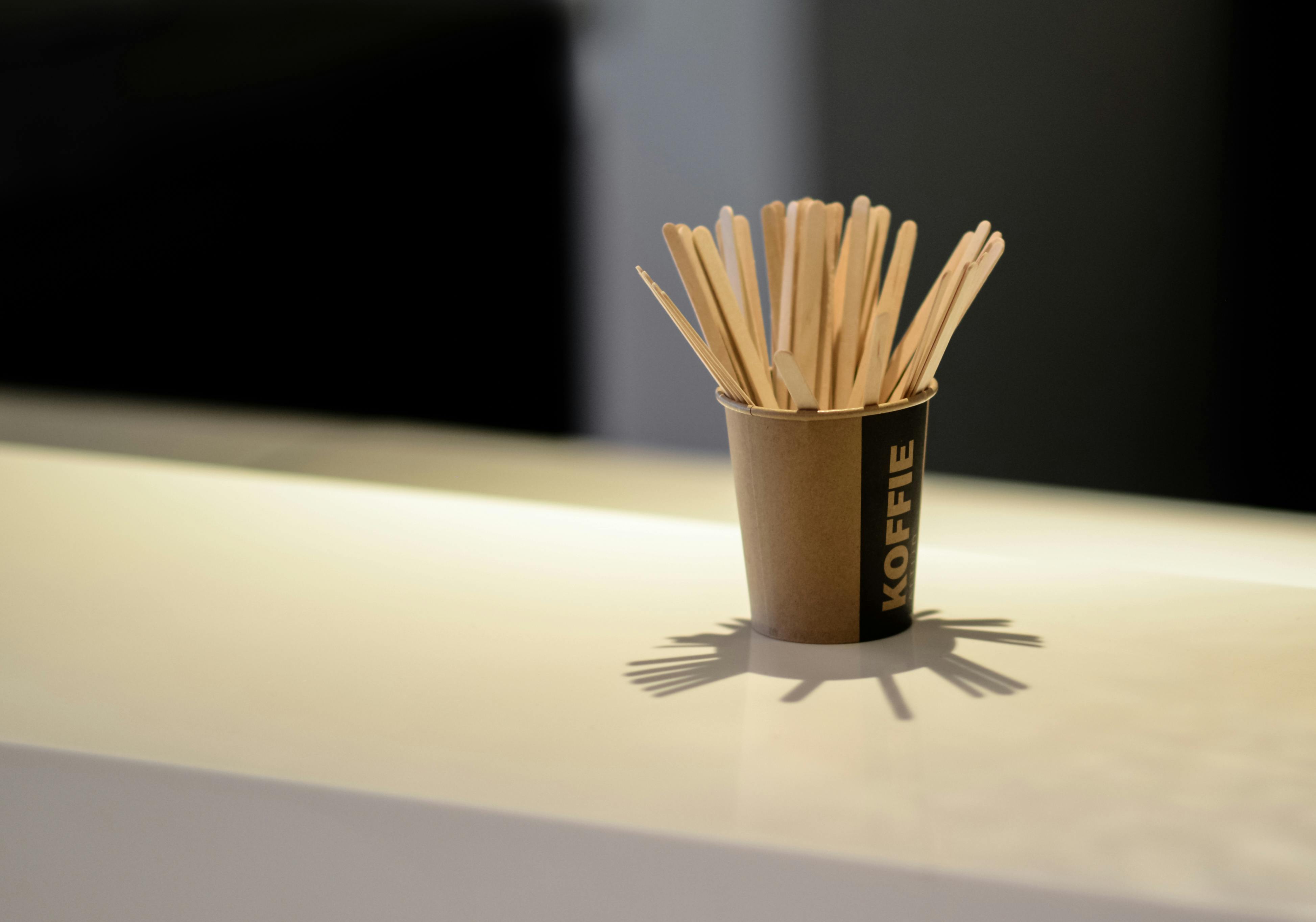 Brown Popsicle Sticks in Brown Disposable Cup \u00b7 Free Stock Photo