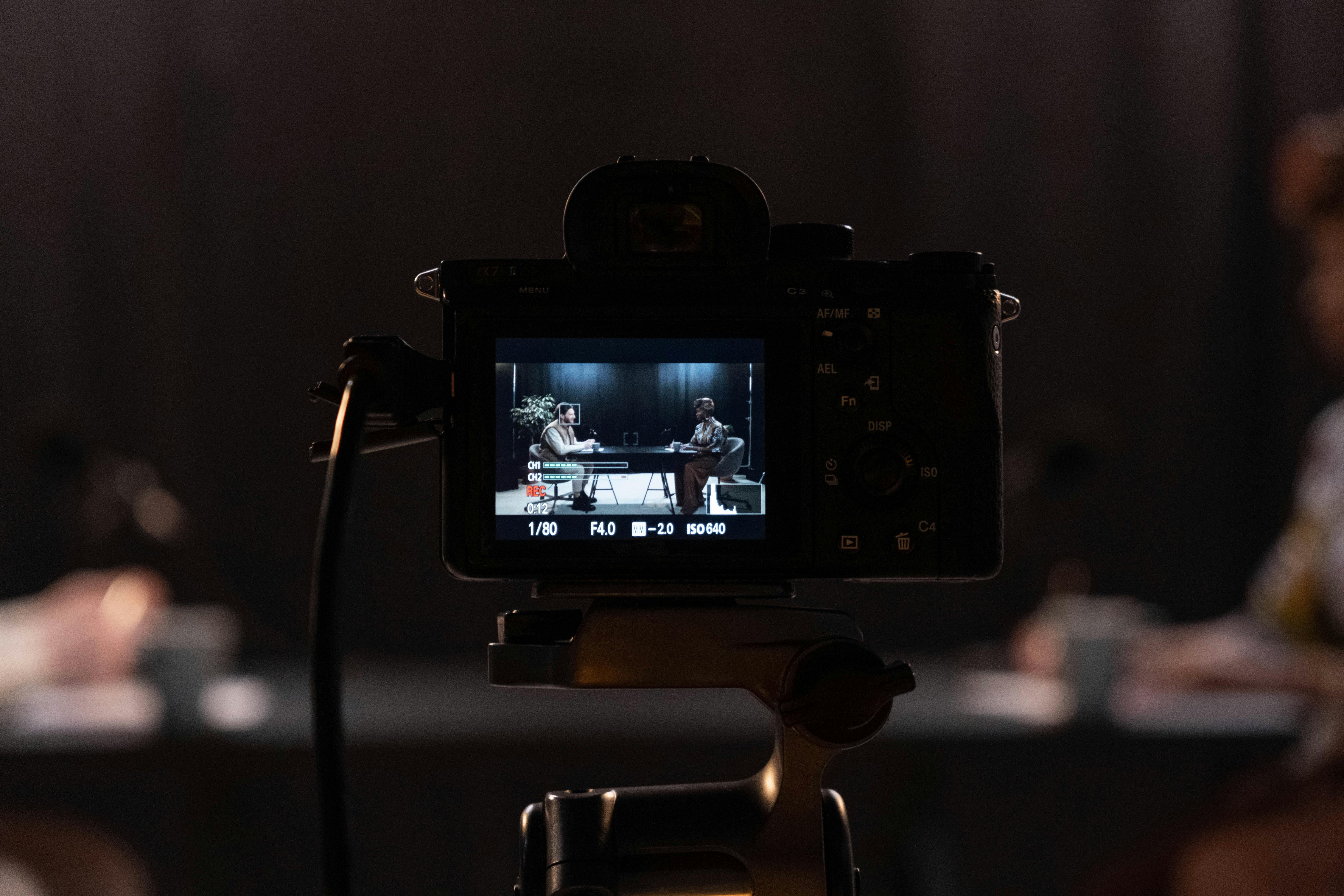 black dslr camera taking photo of a man and a woman