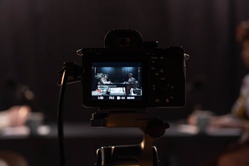 Black DSLR Camera Taking Photo of a Man and a Woman