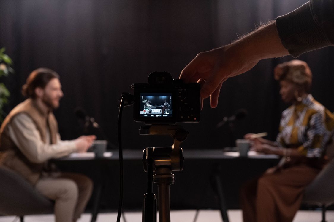 a person holding a black camera