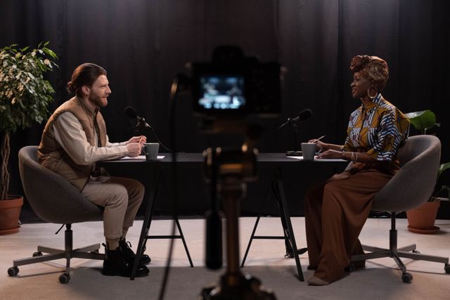 Two people recording an interview in a studio, photo by cottonbro studio on Pexels