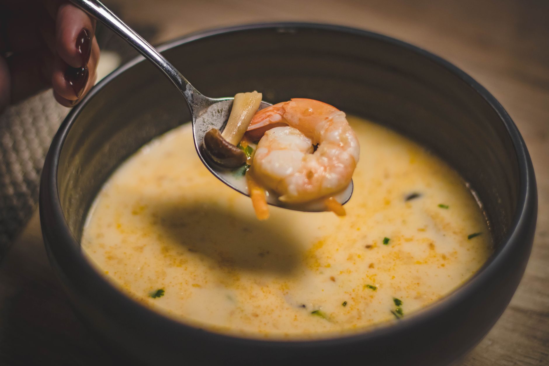 Creamy lobster bisque garnished with herbs