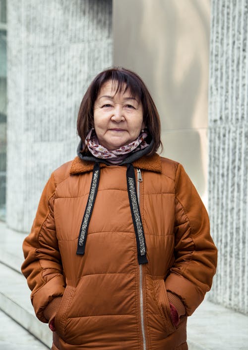 Free Cheerful senior Asian woman in jacket smiling Stock Photo