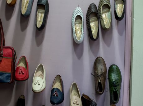 Colorful room slippers on wall display