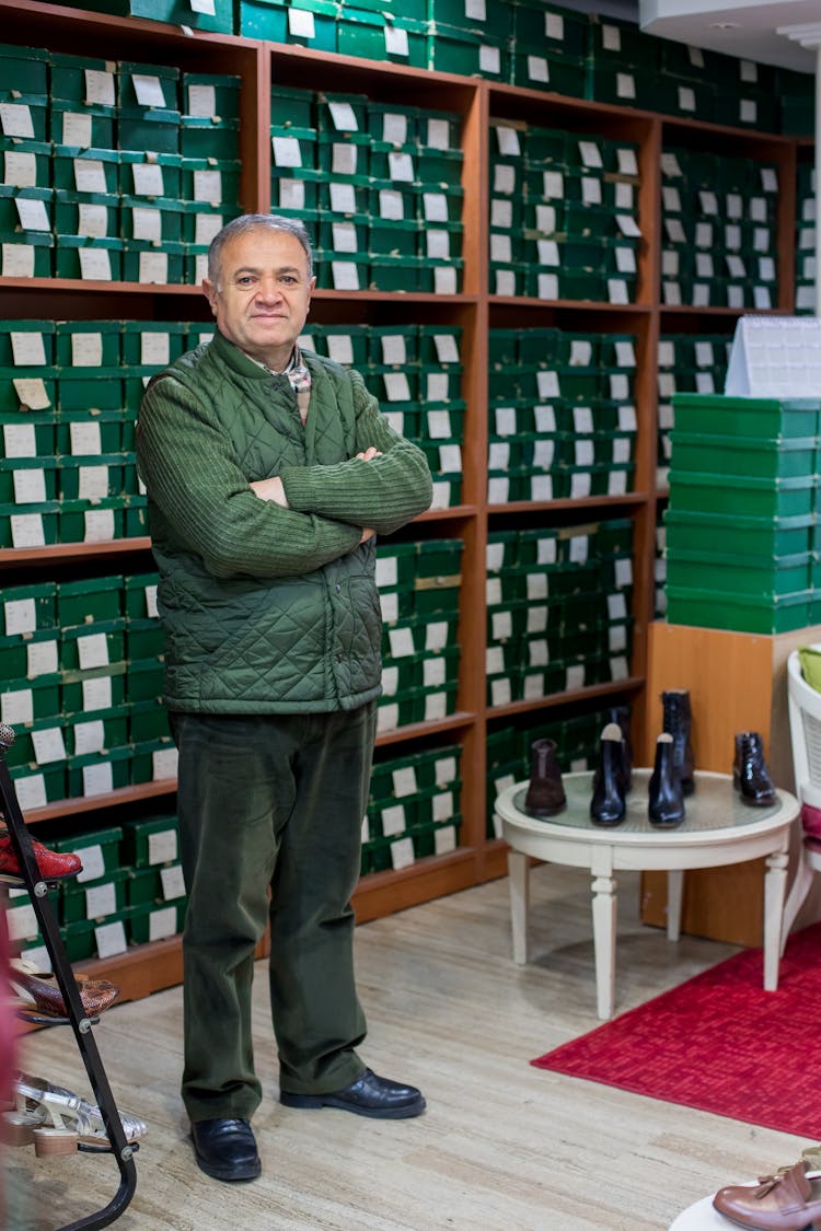 Ethnic Male Customer Standing In Shoe Shop