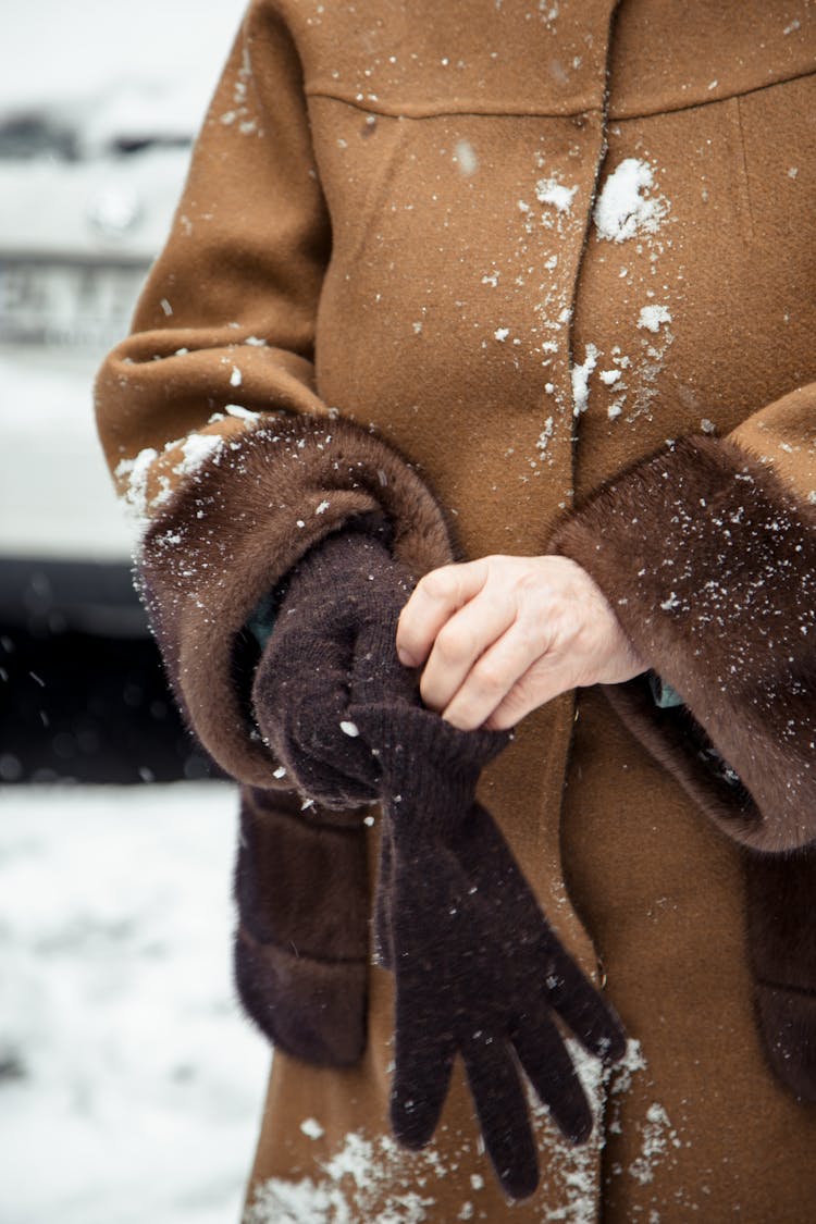 Woman In Warm Clothes Wearing Gloves In Winter Time