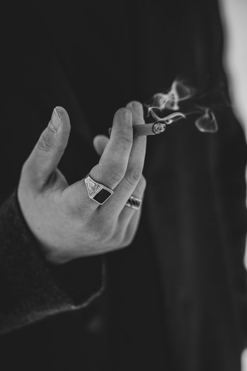 Grayscale Photo of Person Holding a Cigarette · Free Stock Photo