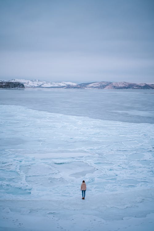 Aerial Photography of a Person Standing on Snow Field