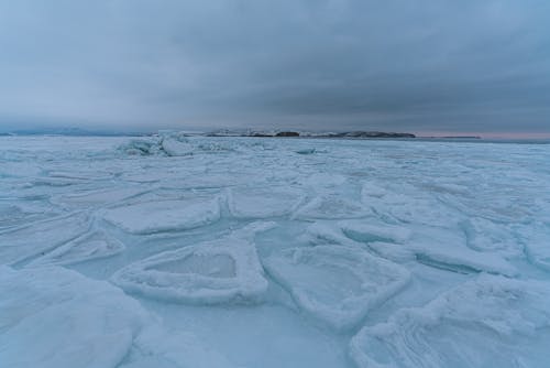 A Snow Covered Landscape Under Blue Sky